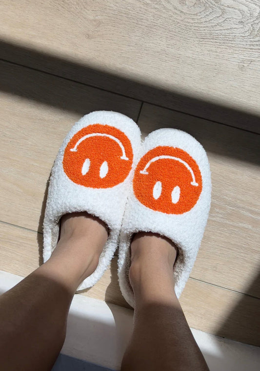 orangey smiley face slippers